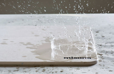 Stone bath mat absorbing water from the bath