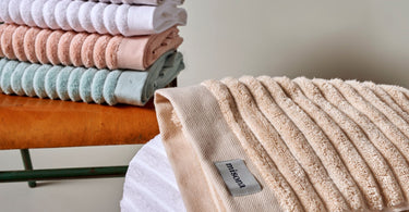 Colourful bathroom towels in pastel tones.