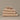 Organic cotton beige bathroom towels. Super soft ribbed towels in four sizes: hand towel, bath towel, bath sheet and face cloths.