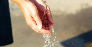 Water Pouring on Person's Hand