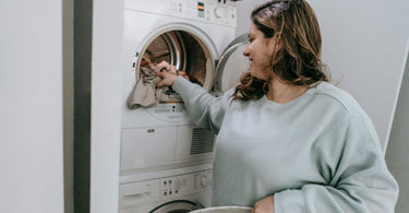 Woman choosing clothes for for washing