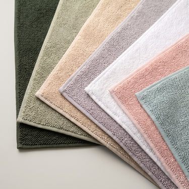 Collection of textured organic cotton loop bath mats in various colours by misona.