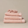 Organic cotton blush pink bathroom towels. Super soft ribbed towels in four sizes: hand towel, bath towel, bath sheet and face cloths. 